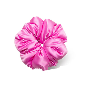 The Hotel Paradiso - Heatwave Padded Scrunchie by us.drowsysleepco is an oversized silk hair accessory in shiny pink satin, arranged in a circular shape and photographed on a white background—perfect for sleep.