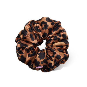 The Hotel Paradiso - Wild Thing Padded Scrunchie by us.drowsysleepco is an oversized silk scrunchie with a brown and black leopard print, shown on a white background to emphasize its shiny fabric and bold style while supporting hair health.