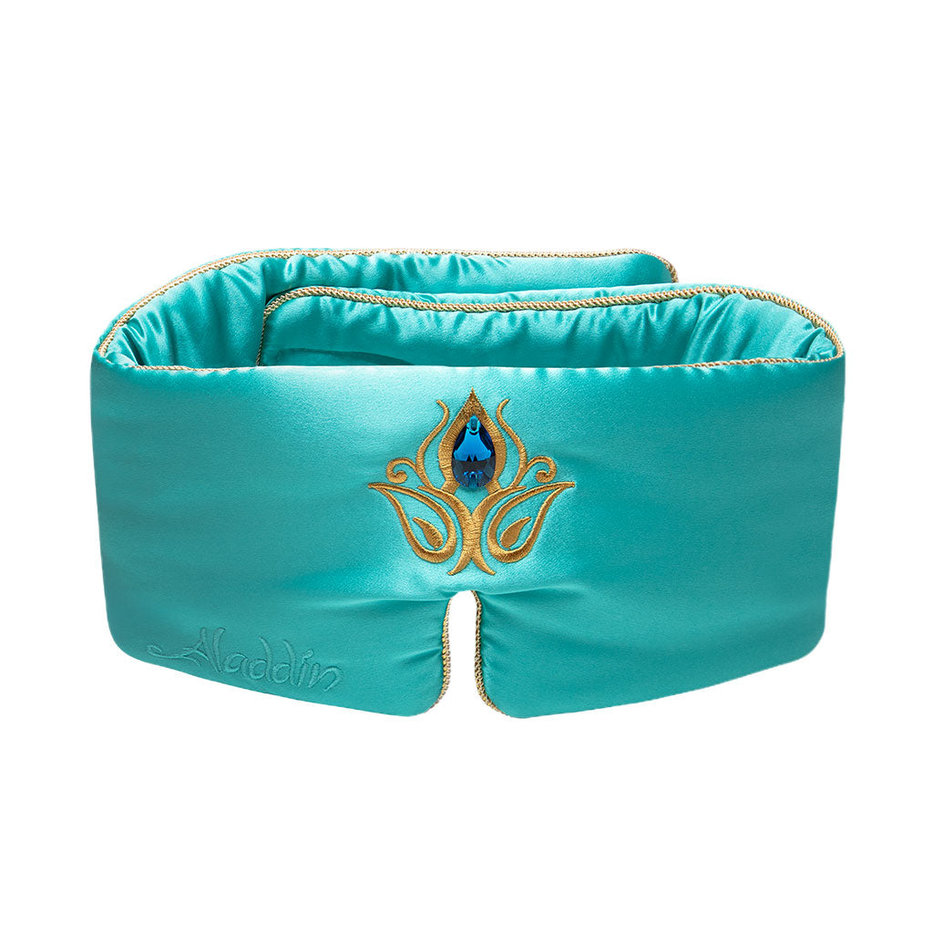The Jasmine Jewel Sleep Mask by drowsysleepco features turquoise mulberry silk, gold embroidery, a central blue gemstone design, and "Aladdin" stitched on the left—an ideal luxurious blackout mask for restful sleep.