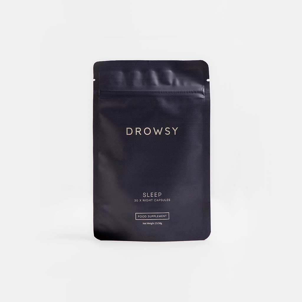 A black resealable pouch labeled drowsysleepco Supplements - Sleep, containing 30 night capsules for relaxation and sleep support, stands upright against a plain light background. The pouch is described as a food supplement.