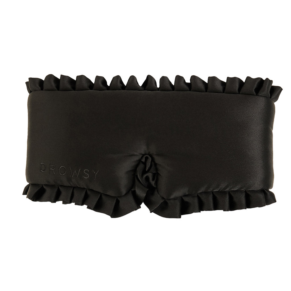 The Sleep and the City blackout sleep mask by drowsysleepco features luxurious mulberry silk, ruffled edges, and Drowsy embossed on the left side for total darkness and restful beauty sleep.