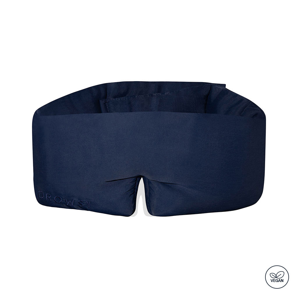The drowsysleepco Midnight Blue - Vegan Silk Sleep Mask features a thick, cushioned design with full blackout coverage and a small vegan certification icon in the corner.