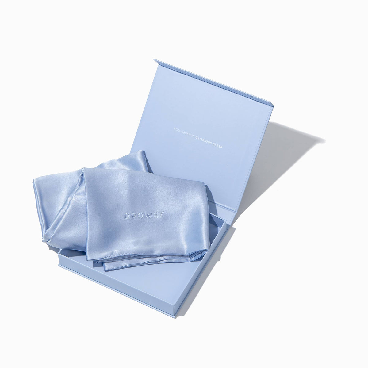 Blue pillowcase box opening with blue silk pillowcase inside