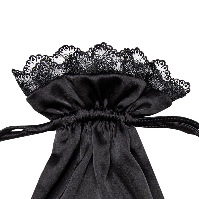 Introducing the Paris Love Story Carry Pouch by drowsysleepco—a black satin drawstring bag adorned with couture-inspired lace ruffled trim and secured with a matching black ribbon, ideal for storing your silk sleep mask or adding a touch of Parisian elegance to your routine.