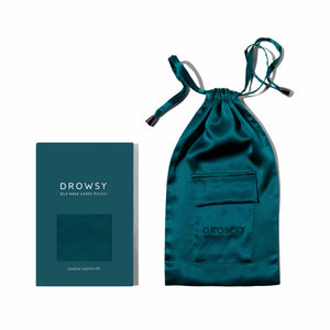 The Green Sapphire Silk Carry Pouch by drowsysleepco features teal mulberry silk, a drawstring closure, and a small front pocket. Comes in a Drowsy-branded box—perfect for storing your silk sleep mask.