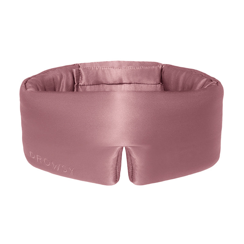The Damask Rose eye mask by drowsysleepco is mauve mulberry silk, features DROWSY embossed on the left and a small notch at the bottom center. Soft, padded, and crafted for comfort.