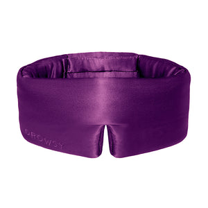 The Purple Martini sleep mask by drowsysleepco features a padded, wraparound design and ultimate light blocking for deep beauty sleep, with "DROWSY" embroidered on its purple silk side.