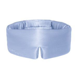 The Blue Belle silk sleep mask by drowsysleepco features DROWSY embroidery on the side. Shown here in light blue, this blackout eye mask is set against a white background.