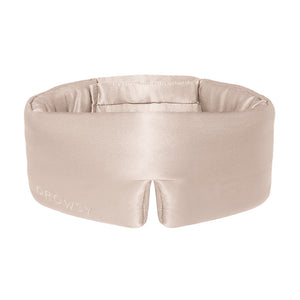 The Dusty Gold sleep mask by drowsysleepco is a beige silk blackout eye mask with a wide, padded design and small bottom notch—ideal for uninterrupted beauty sleep.