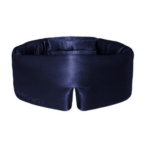 The Midnight Blue sleep mask by drowsysleepco features thick, padded sides and DROWSY embroidery on the front. Made from dark blue mulberry silk, it is designed to block out light completely for restful sleep.