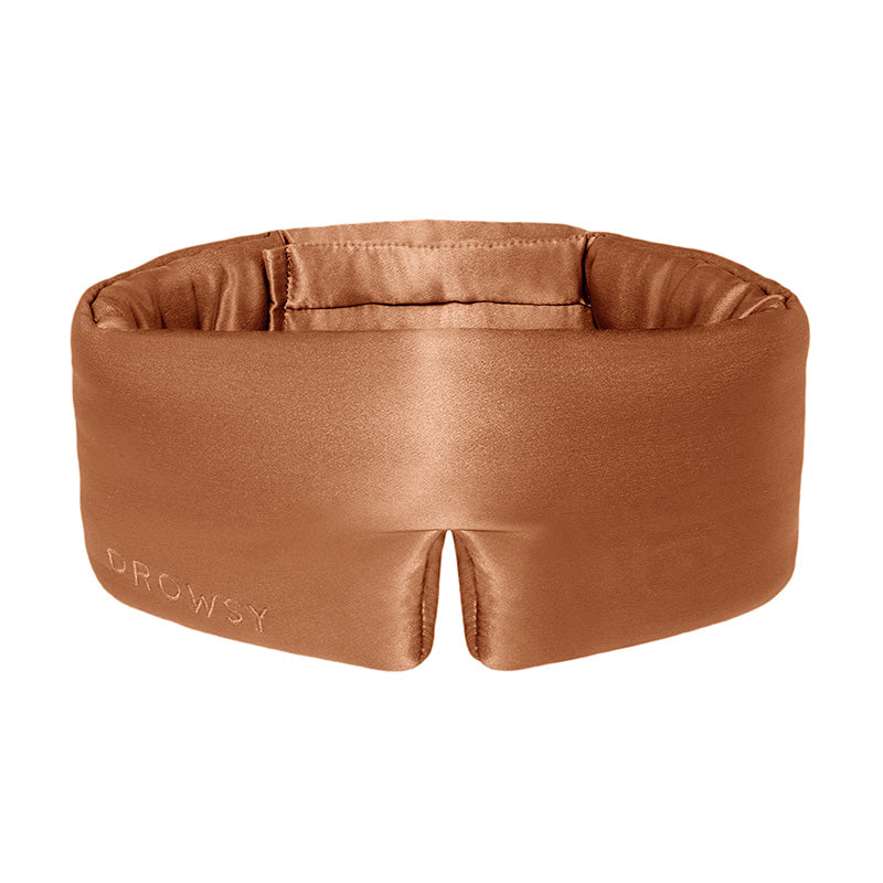 Burnt orange coloured Drowsy silk sleep mask on a white background