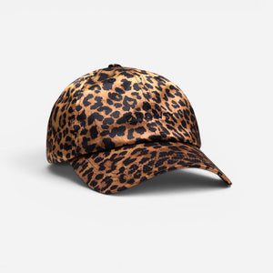 The Drowsy Silk Cap - Hotel Paradiso Wild Thing by Drowsy features a chic brown and black leopard print, offering stylish hair protection and shown against a plain white background.
