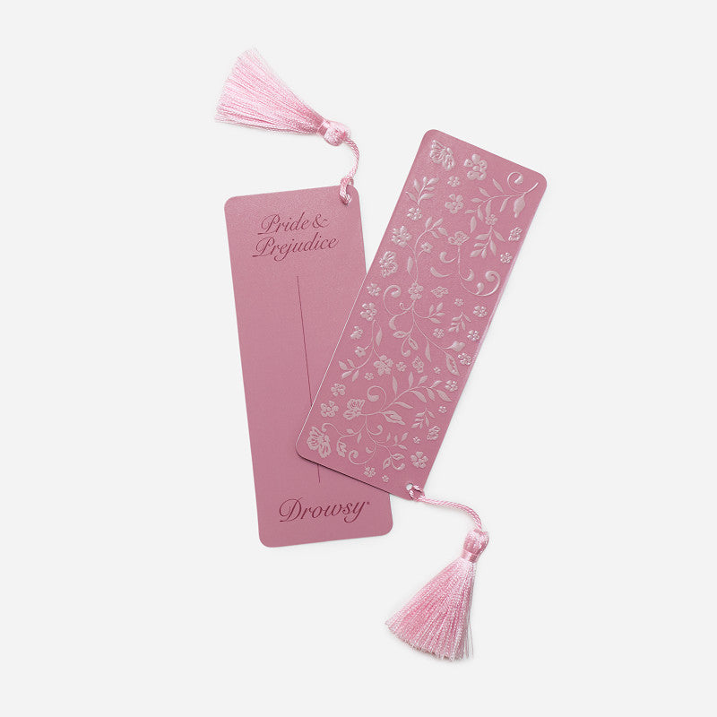 Two pink bookmarks with matching tassels, one floral and one reading Pride & Prejudice, displayed with a Pride & Prejudice - English Rose Eyelash Protecting Sleep Mask.