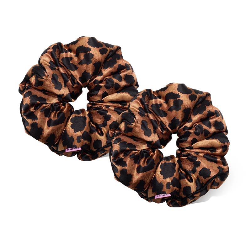 Two Hotel Paradiso - Wild Thing Padded Scrunchies by us.drowsysleepco, featuring silky leopard print, sit side by side on a white background. These oversized scrunchies promote hair thickness and add a bold, stylish touch.