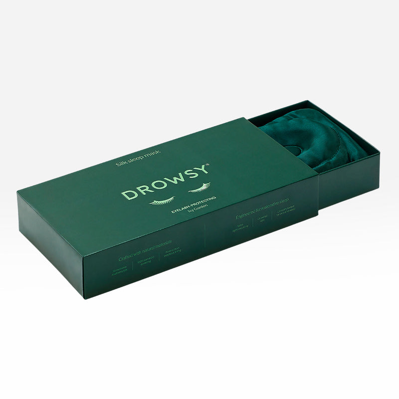 Dark green silk Ivy Garden - Eyelash Protecting Mask partially inside its matching rectangular storage box.