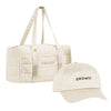 The Drowsy Roadtrip bundle in Dusty Gold includes a cream duffel bag and matching cap, both embroidered with "DROWSY" in black—ideal for stylish travel hair care and effortless protection, shown on a plain white background.
