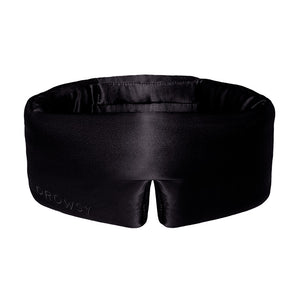 The Black Jade by drowsysleepco is a black silk, contoured eye mask with a subtle notch at the bottom center. “DROWSY” is elegantly embossed on the lower left, making it a stylish blackout sleep mask designed for beauty rest.