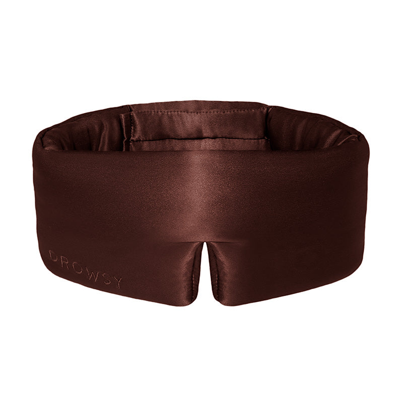 Brown, padded silk sleep mask designed to block out light and provide comfortable sleep.