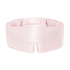A woman with long brown hair wears the us.drowsysleepco Petal Pink adjustable sleep mask, which covers her eyes and nose. She is dressed in a white shirt and stands against a simple, light background.