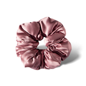 The drowsysleepco Damask Rose - Padded Scrunchie is a shiny, silky pink oversized hair accessory with a smooth texture, shown in a circular shape on a white background—ideal for comfortable sleep.