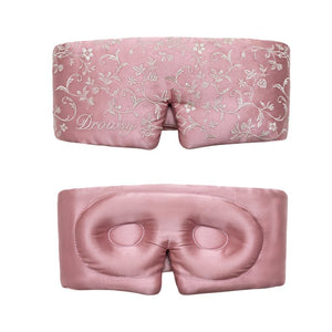 A front and back view of the Pride & Prejudice - English Rose Eyelash Protecting Sleep Mask, featuring a pink design with white floral embroidery and contoured eyecups to protect eyelashes.
