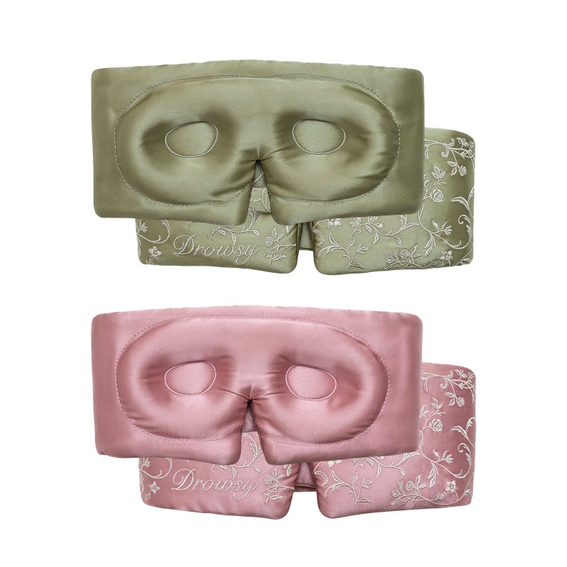 Two Pride & Prejudice - Sage + English Rose Eyelash Protecting Masks in sage green and dusty pink, featuring eye contours and a floral pattern on the lower strap.