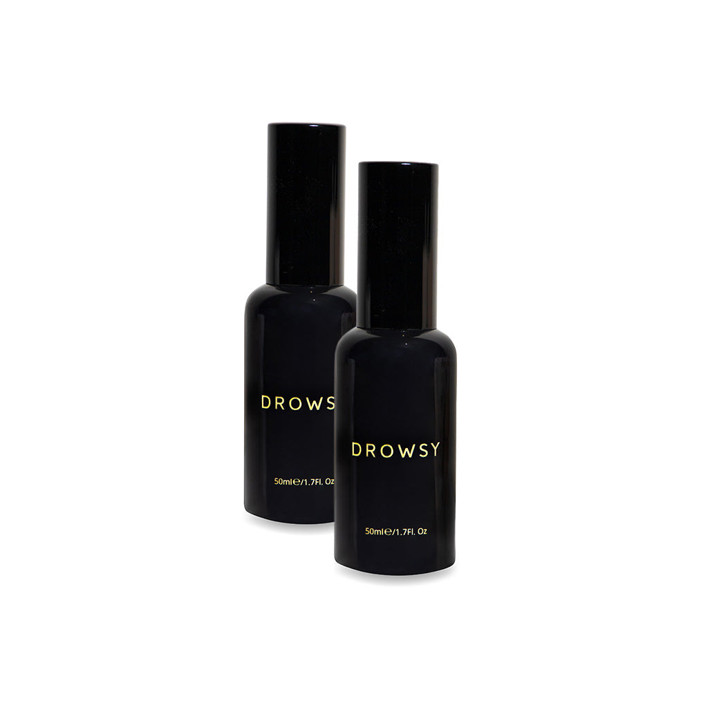 Two black 50ml bottles with black caps, labeled "Sleep S.O.S Pillow Spray" by drowsysleepco, stand side by side on a white background. These natural sleep aids are perfect for enhancing your nightly sleep ritual.